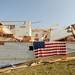 A flag hangs over the side of a home that was severely damaged by Thursday's tornado in Dexter. Angela J. Cesere | AnnArbor.com